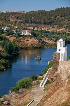 Clock tower (Torre do Relogio) on the right bank of Guadiana. Mertola. Por... Fotos Stock