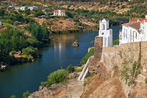 Clock tower (Torre do Relogio) on the right bank of Guadiana. Mertola. Por... Fotos Stock