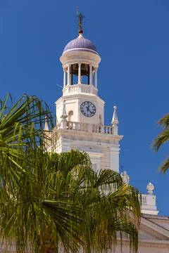Clock tower on the tower of the bell tower in the Spanish Cadiz. Stock Photos