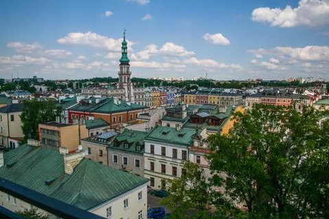 Clock tower of town hall over roofs Stock Photos