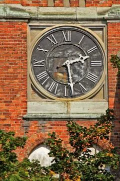 Clock on the wall of the building Stock Photos