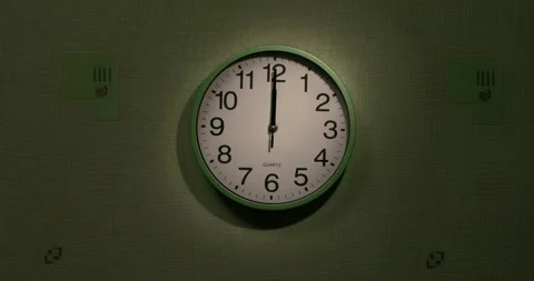 The clock on the wall displays the time twelve o'clock. Video stock 258613723