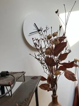 Clock on the wall dry flowers Stock Photos