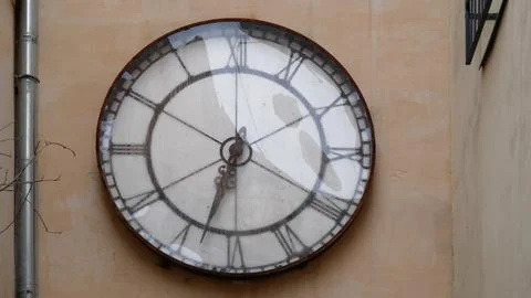 A clock on the wall of the house Stock Photos