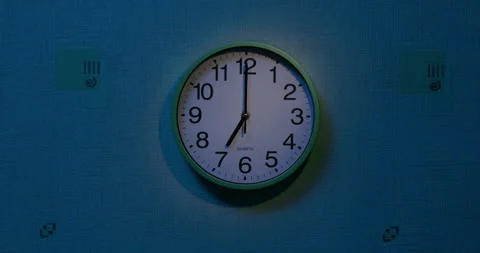 The clock on the wall reads seven a.m. - wake-up time. Stock Footage 258613948