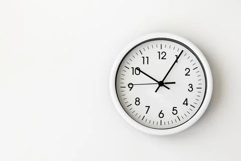 Clock, white arrow clock on white background woman's hand holding a round clock Stock Photos