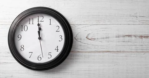 Clock on a white background. A minute to twelve. Banner. Place for your text. Stock Photos