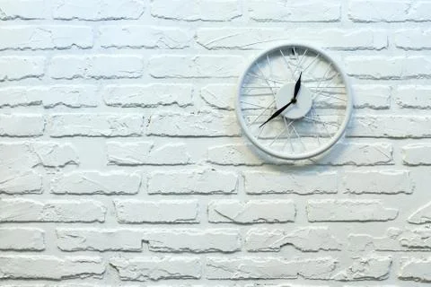 Clock in white brick wall. Background. Texture. Brick. Stock Photos