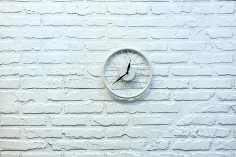 Clock in white brick wall. Background. Texture. Brick. Stock Photos