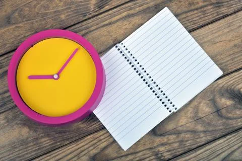 Clock on wooden table Photos
