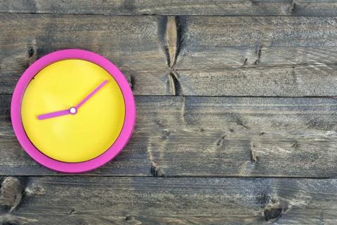 Clock on wooden table Stock Photos