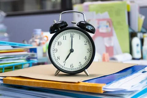 Clock on work desk in the office Time of businessman working concepts Stock Photos