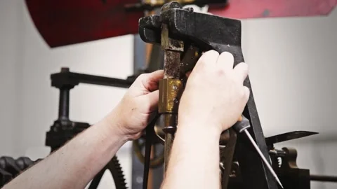 Clockmaker Adjusting an Antique Clockwork Mechanism 库存影片 345750324