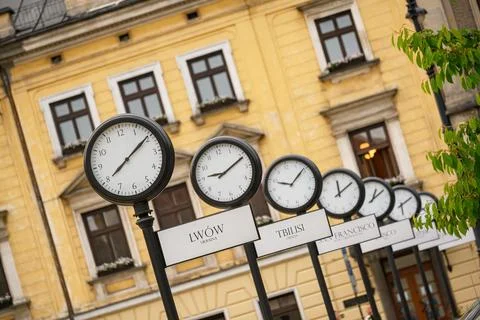 Clocks showing the current time in cities around the world. Krakow, Poland Stock Photos