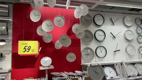 Clocks on wall hanging for sell in IKEA Store Bang Yai. Red and white background Video stock 172352184