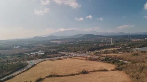 Clockwise Hyperlapse Aerial View of a Busy Crossroad with Hallasan in View, Jeju Stock Footage 146067616