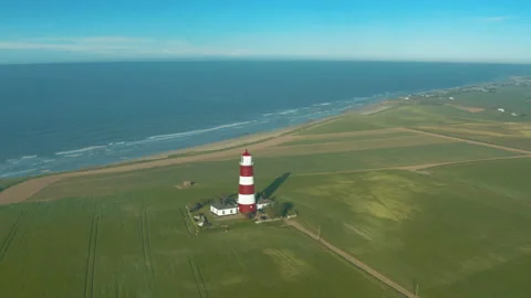 Clockwise parallax shot of Happisburgh Lighthouse with the beach and big Stock Footage 132911411