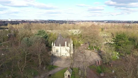CLOCKWISE SHOT OF A RED CAR AND PEOPLE MOVING IN THE CEMETERY Stock-Footage 150763499