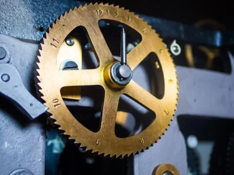 Clockwork close-up. Bronze clock gear with numbers Stock Photos