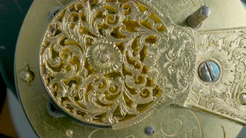 Clockwork mechanism macro. Round wheel with a carved pattern from curlicue on an Video stock 201597454