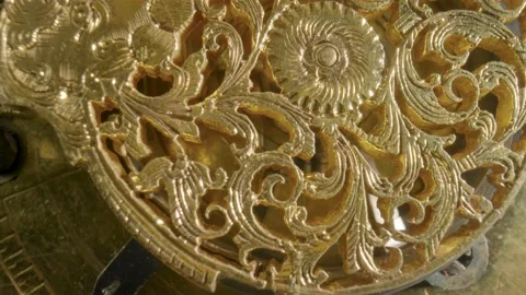 Clockwork mechanism macro. Round wheel with a carved pattern from curlicue on an Video stock 201601873