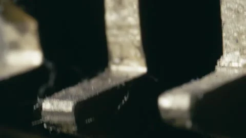 Clockwork rhythmic action of metal cog wheel mechanism turning MACRO Stock Footage 314719809