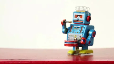 Clockwork robot with foots falls from table, beats drum Stock Footage 2348445