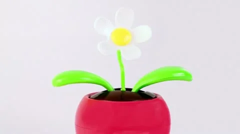 Clockwork toy flower tilts from one side to another Stock Footage