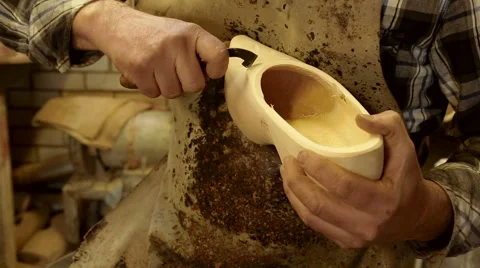 Clog maker is cutting decoration in clog with a gouge Stock Footage 46996182