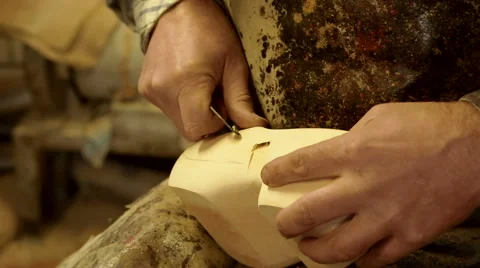 Clog maker is cutting decoration in clog with a gouge Video stock 46996411