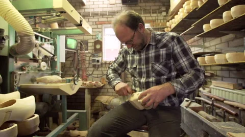 Clog maker is cutting decoration in clog with a gouge Video stock 47074485