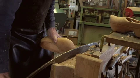 Clog maker cutting of the edges of a clog Stock Footage 47073478