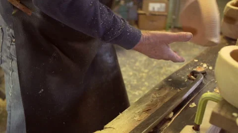 Clog maker cutting of the edges of a clog [SLOMO] Stock Footage 47074155