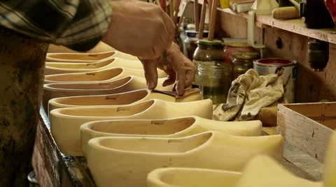 Clog maker is drawing cutting lines on the clogs Video stock 46994232