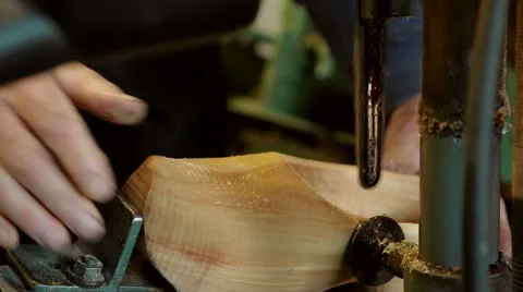 Clog maker drills a hole in the side of clog Stock-Footage 46996479