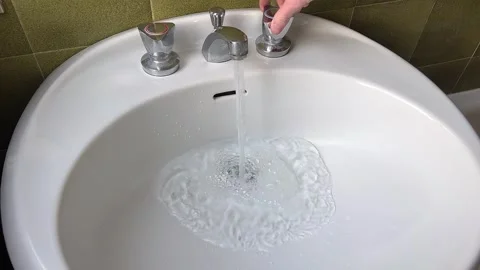 Clogged sink, with water draining slowly and requiring intervention Stock Footage 305842520