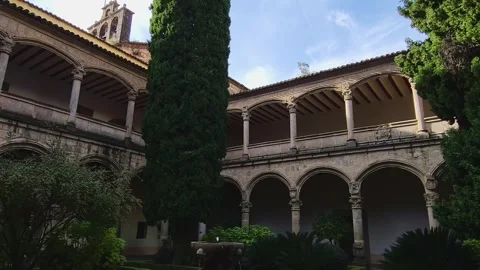 Cloister of the Monastery of Yuste. Stone arches on two levels, a stone Stock Footage 341528089