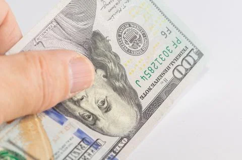 A close-up of a 100 dollar bill in a hand Stock Photos