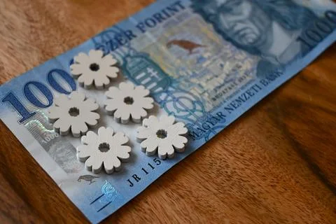 Close-up of a 1000 forint banknote on a table decorated with spring flowers, sym Photos