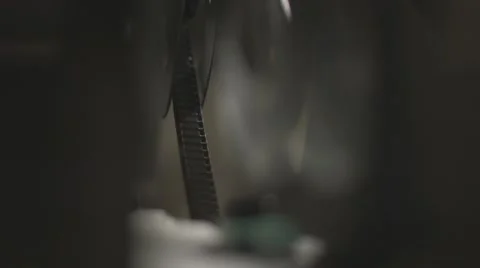 Close up of 16mm film rolling in vintage projector Stock Footage