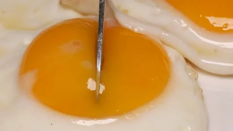 Close Up Of 2 Eggs, Sunny Side Up, Being Cut, London, UK. Stock Footage 225269895
