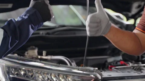 Close up of 2 mechanic hands in gloves making handshake and thumb up Stock Footage 246119851