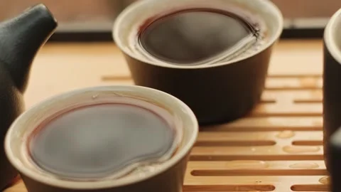Close-up 2 tea bowls on Tea tray. Puer tea. Chinese tea ceremony. Stock-Footage 295279435