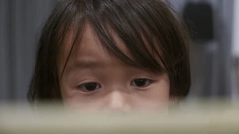 Close Up of a 2 year old toddler watching a video on an iPad, Tablet. Stock Footage 140612235