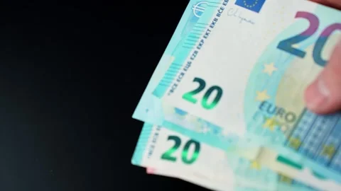 Close-up of 20 euro banknotes on a dark background with copy space, ideal for Vidéo 329593812