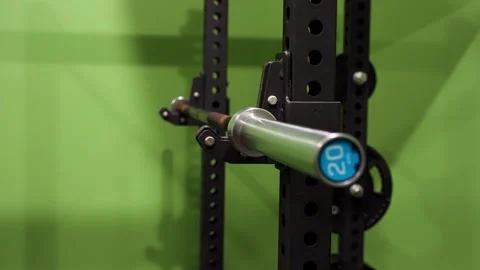 Close up of 20 kilogram barbell on squat rack in physiotherapy gym Stock Footage 330584082