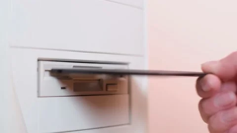Close-up of a 3-inch floppy disk inserted into the system unit. Scanning a Stock Footage 196791889
