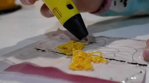 Close-up of 3D pens in the hands of a child. The child draws with a 3D pen. Stock Footage 229418746