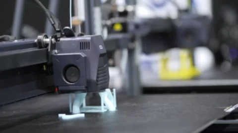 Close-up of 3D printer creating small plastic part Stock Footage 346147211
