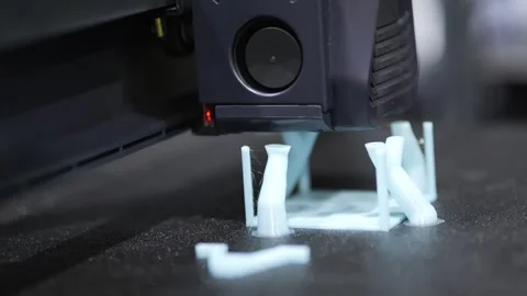 Close-up of 3D printer creating white plastic object Видео 344688067